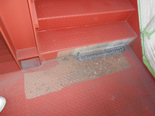階段の段板の腐食箇所を鉄板で塞いだ状況